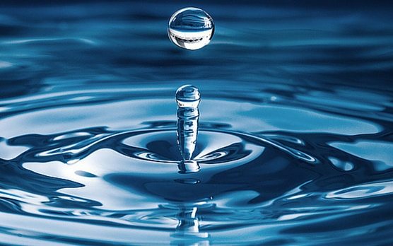 a drop of water splashing into water